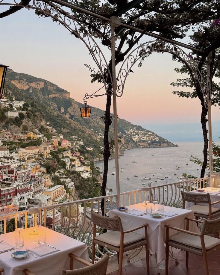 A terrace restaurant above the sea at dusk